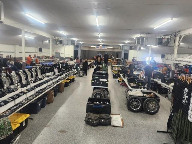 Vendor tables of motorcycle parts at an indoor swap meet